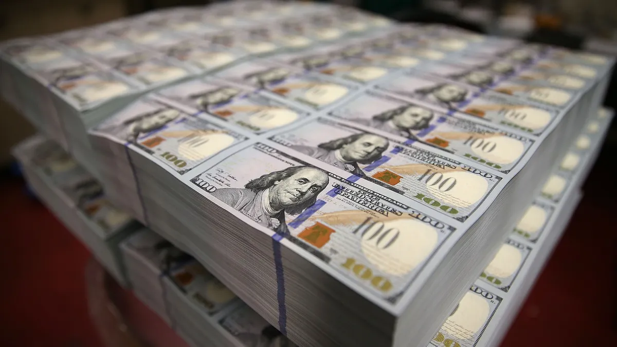 Newly redesigned $100 notes lay in stacks at the Bureau of Engraving and Printing on May 20, 2013 in Washington, DC.