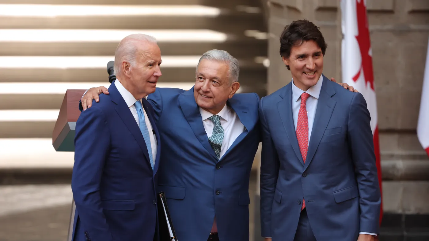 U.S. President Joe Biden, President of Mexico Andres Manuel Lopez Obrador and Prime Minister of Canada Justin Trudeau hug each other.