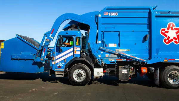 A Republic Services truck and dumpster.