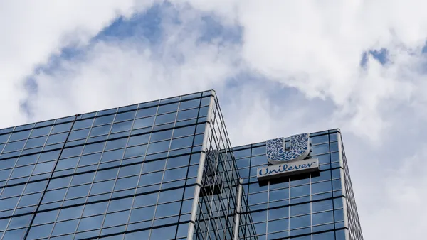 company signage bearing Unilever's logo on a headquarter office against a clear sky