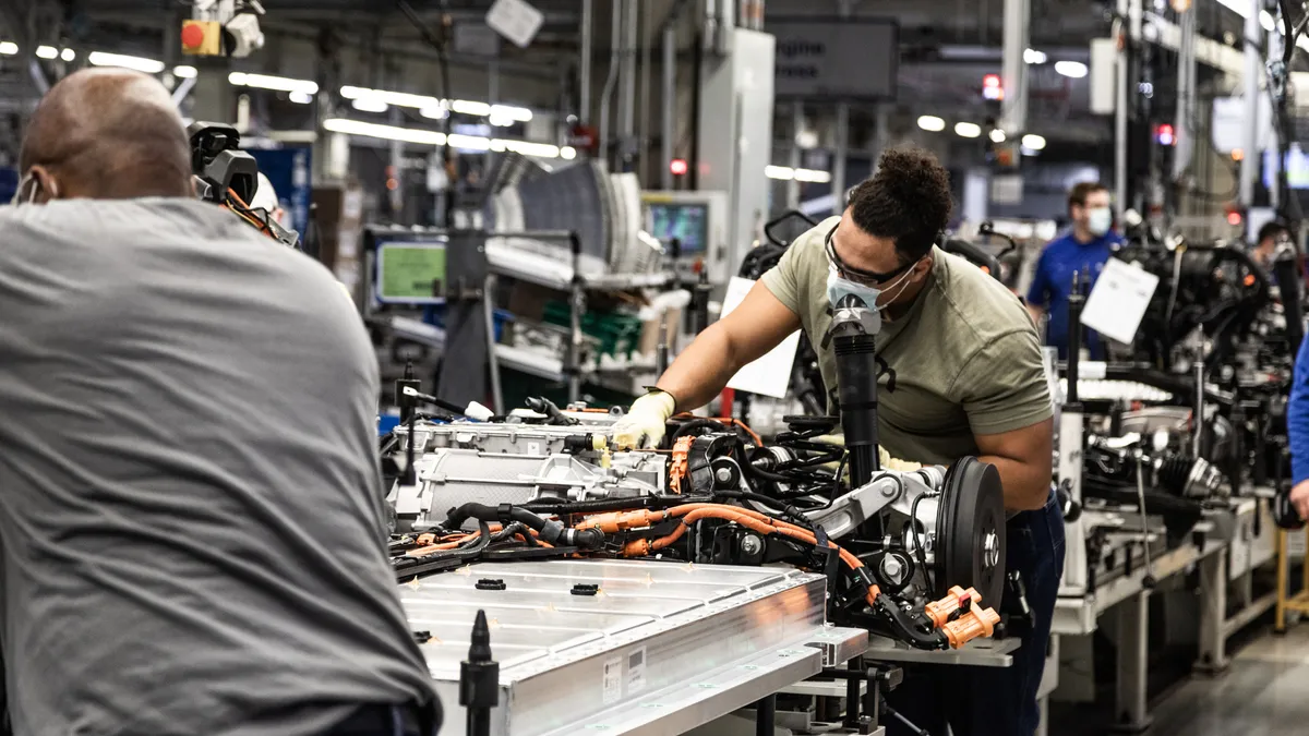 Autoworkers assemble a battery pack for an electric vehicle at the Volkswagen Group's assembly plant in Chattanooga, Tennessee.