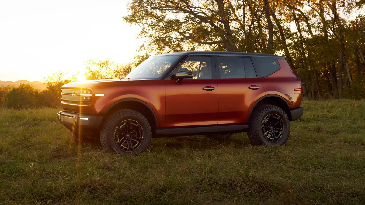The Scout Traveler SUV parked outdoors with a setting sun in the background.