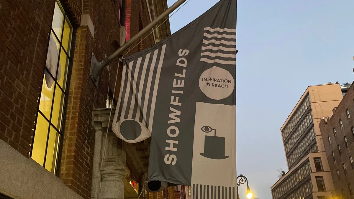 Showfields logo flag flies outside of its storefront.