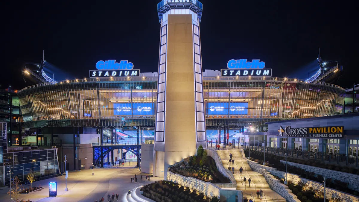 A photo of a large structure near stairs at night, lit up brightly.
