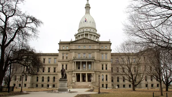 The Michigan State Capitol on a winter day. A stone building with a dome.