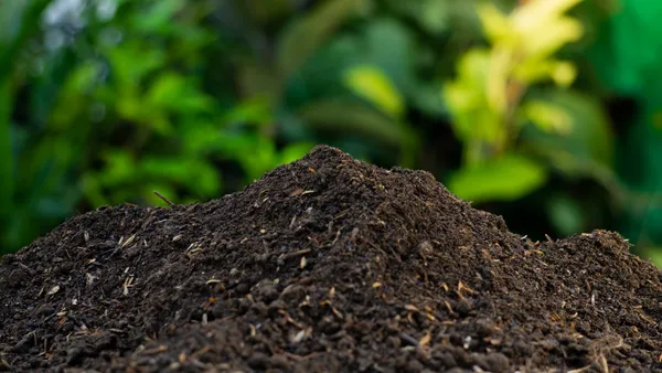 A compost pile in front of green background