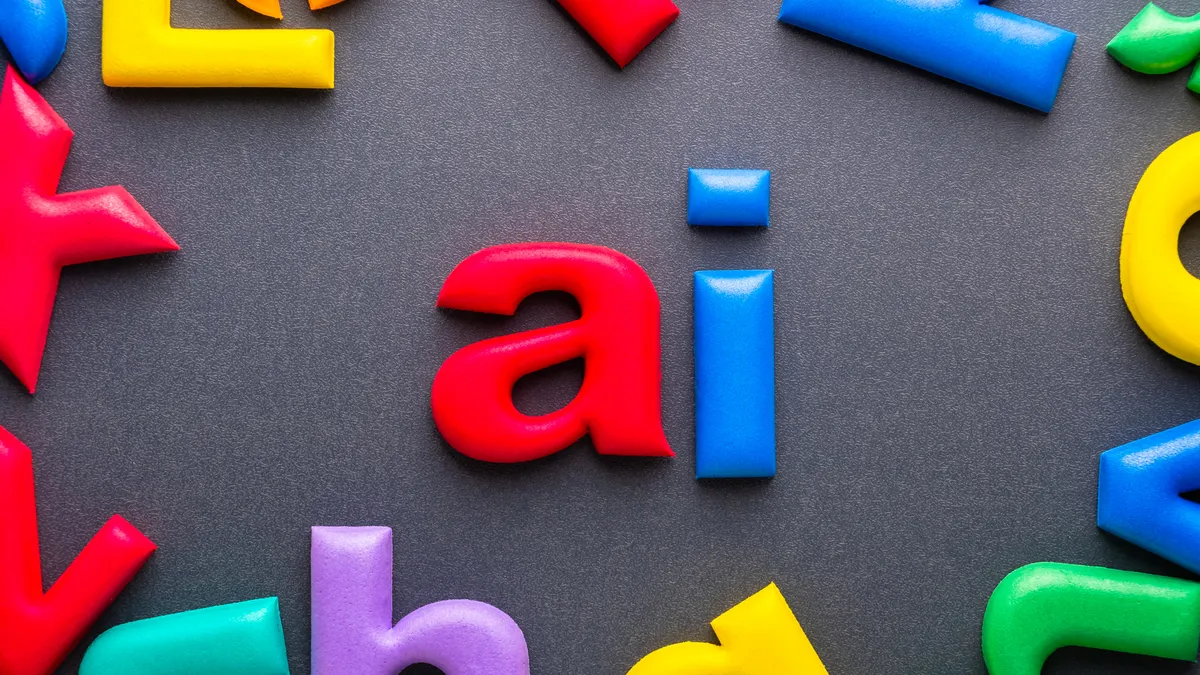 Bright foam alphabet letters forming the word AI on gray surface symbolizing artificial intelligence learning and modern communication tools