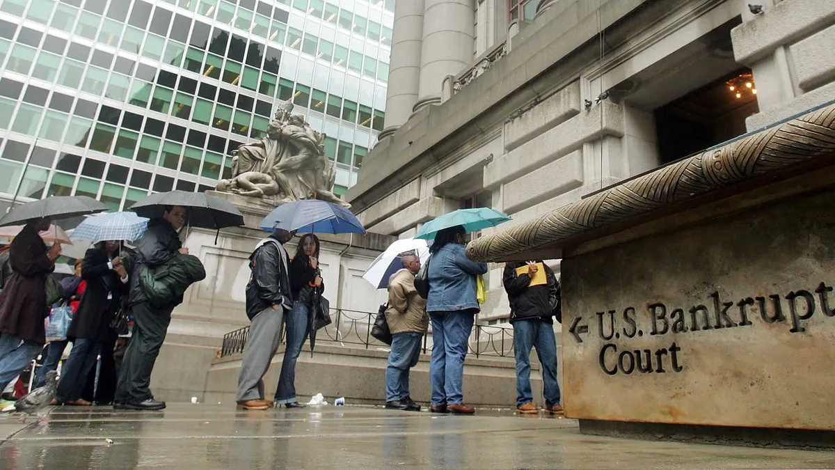 Image shows people standing outside a U.S. Bankruptcy court.