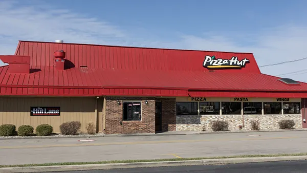 An image of a brick building with Pizza Hut logo on the side.