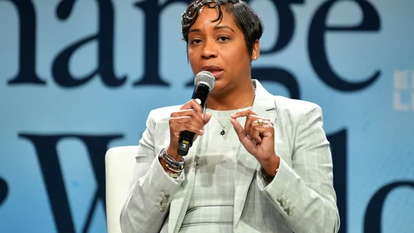 Andrea Joy Campbell speaking into a microphone