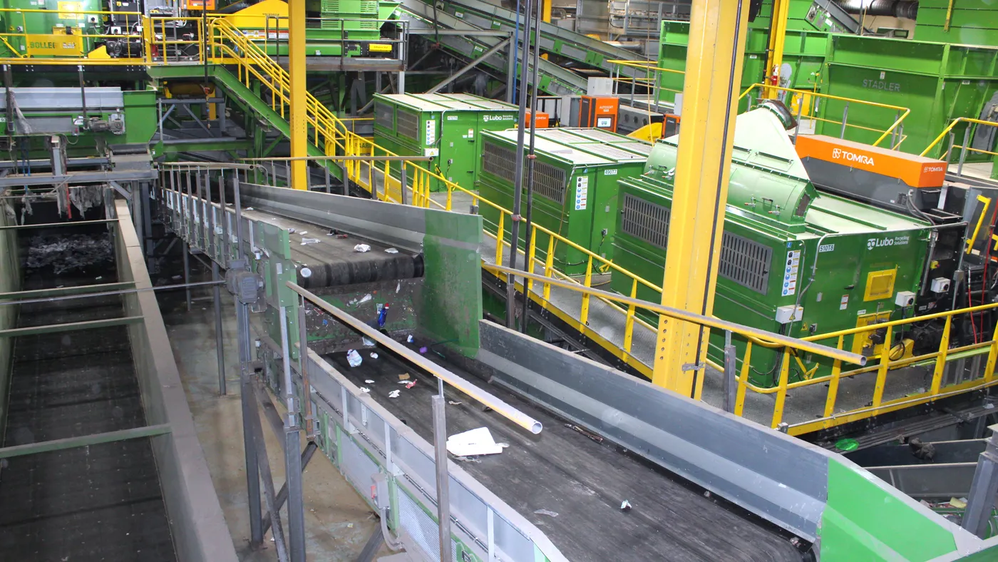 Industrial equipment and conveyors process materials for recycling.