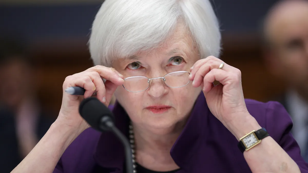 Treasury Secreatry Janet Yellen peers behind her glasses on Capitol Hill.