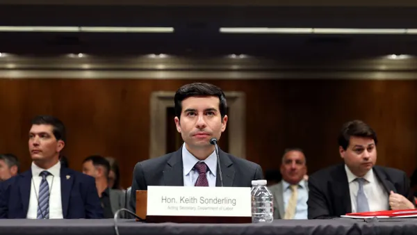 Keith Sonderling sits at a table and a microphone during a congressional subcommittee meeting.