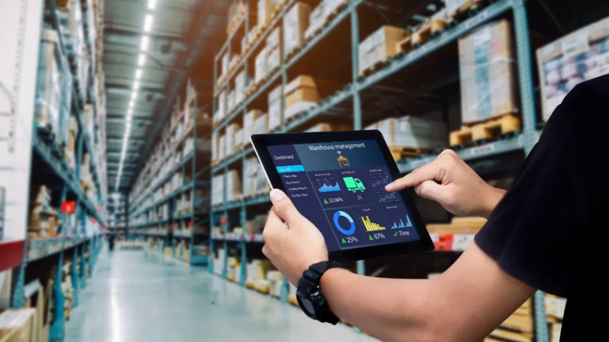 Worker using tablet in warehouse