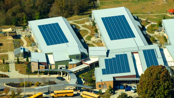 Roof of american school building covered with photovoltaic solar panels