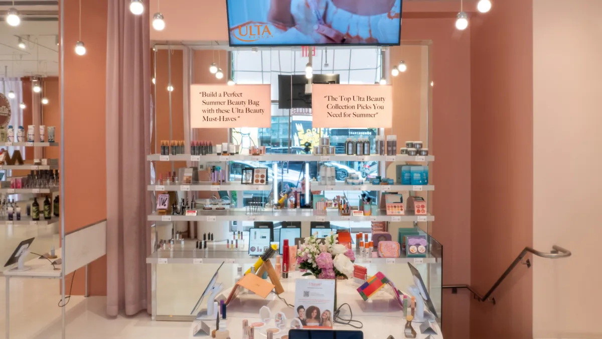 Ulta Beauty makeup products are on display in a pink-walled room at the Allure Store.