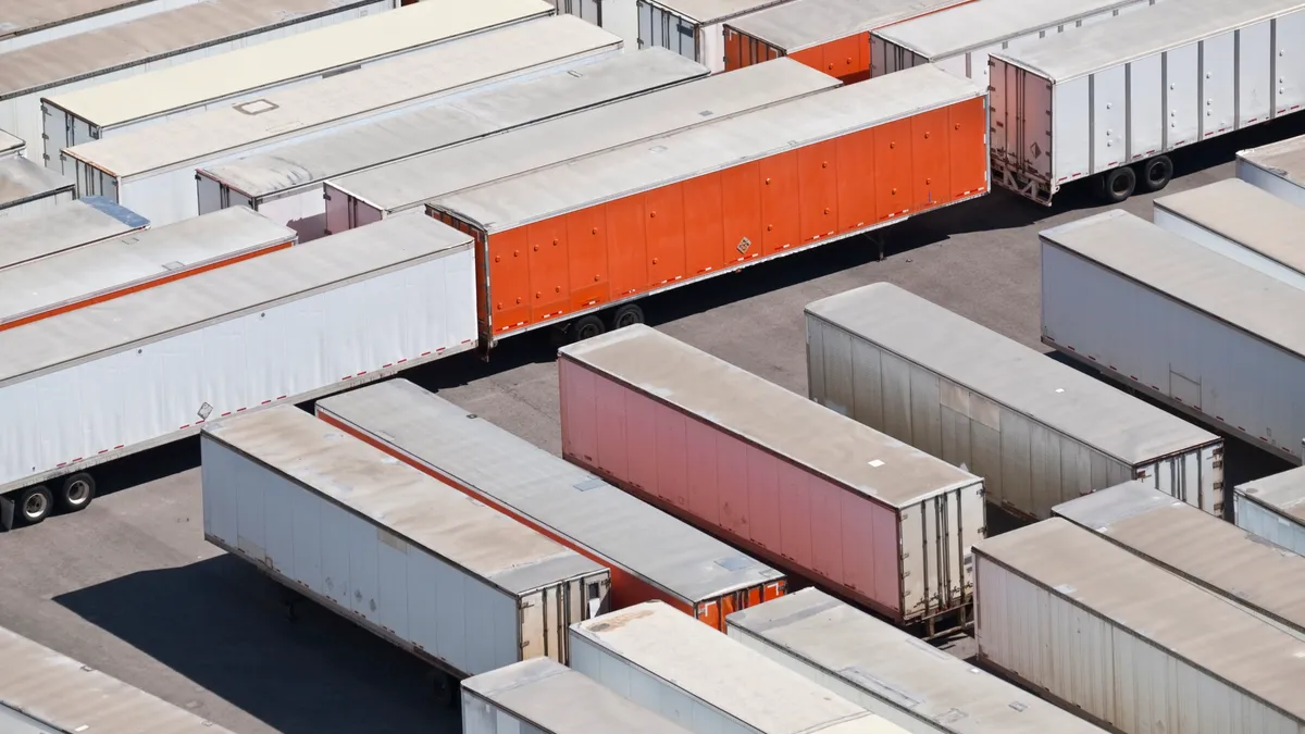 Trailer storage yard aerial in bright desert sun.