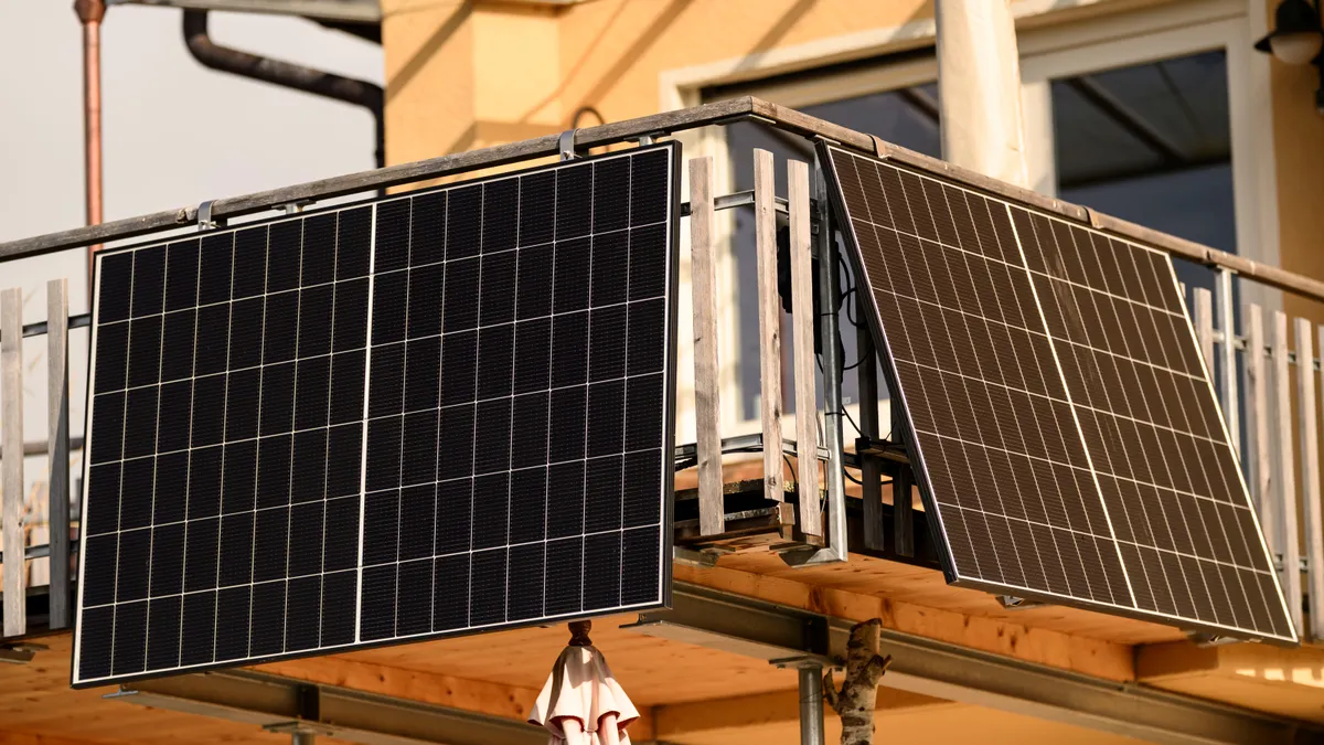 Solar panels hang from a balcony in Riegsee, Germany.
