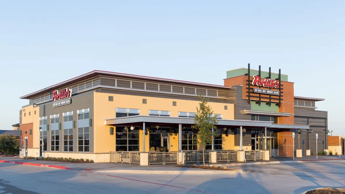 A beige restaurant with Portillo's signage in Allen, Texas