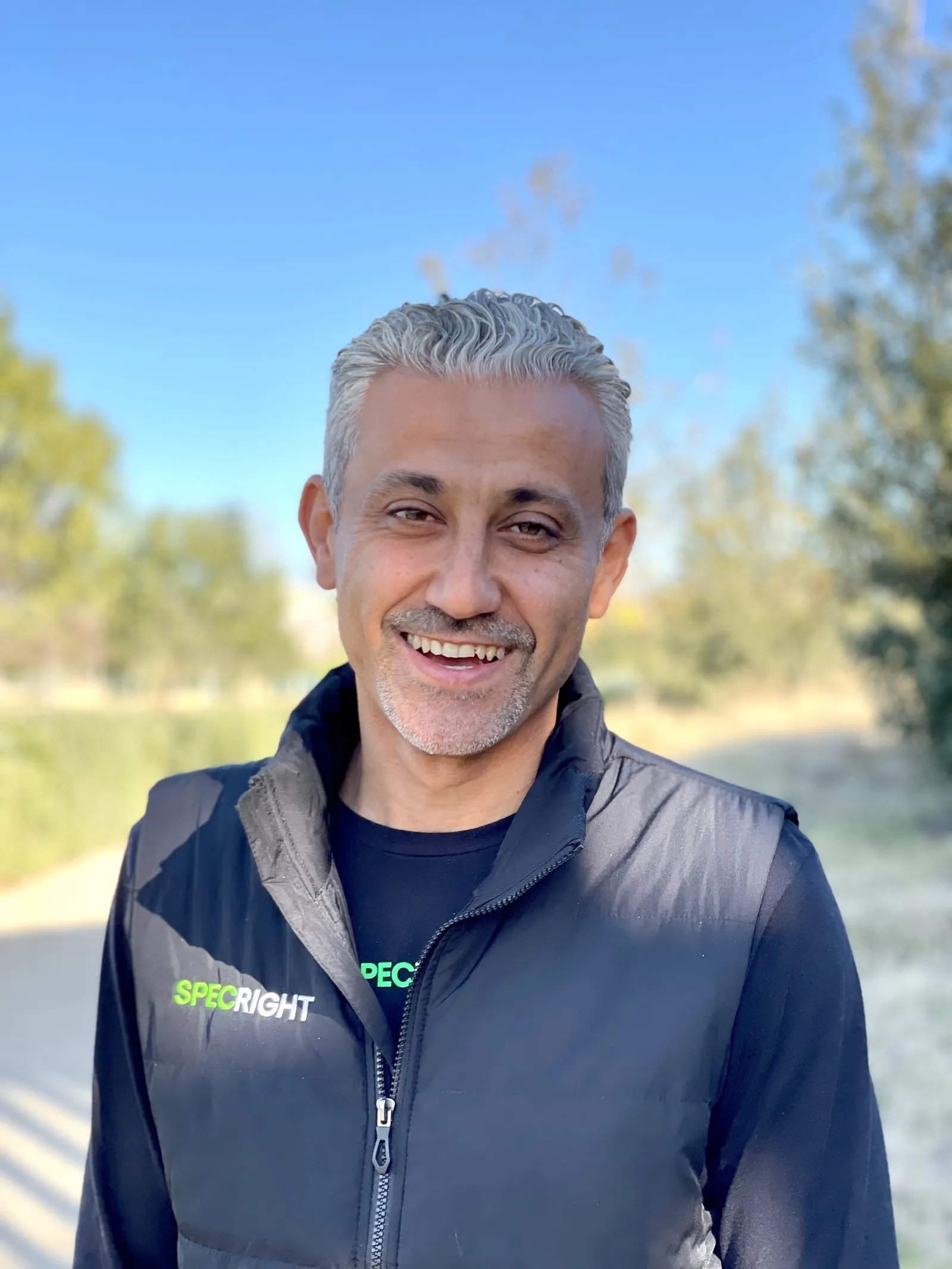 Man standing in vest with Specright logo