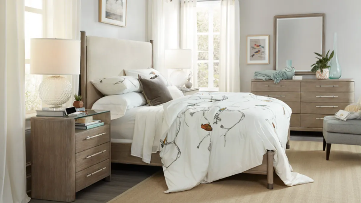 A bed with a nightstand in a room.