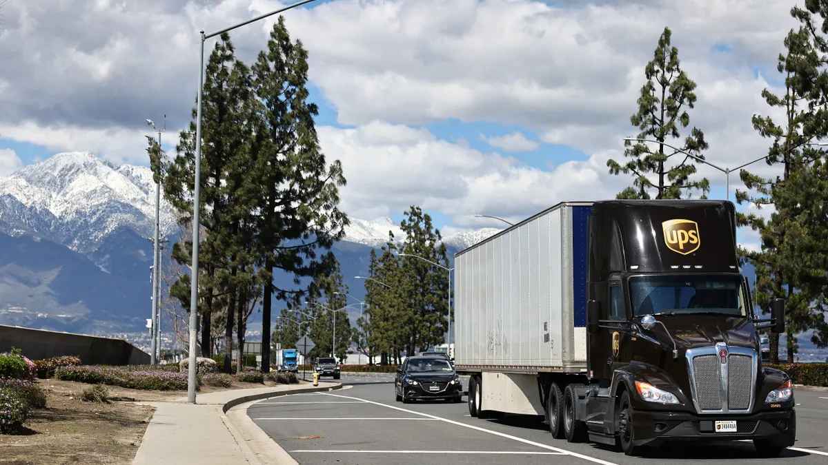 Shot of UPS truck driving down an open road