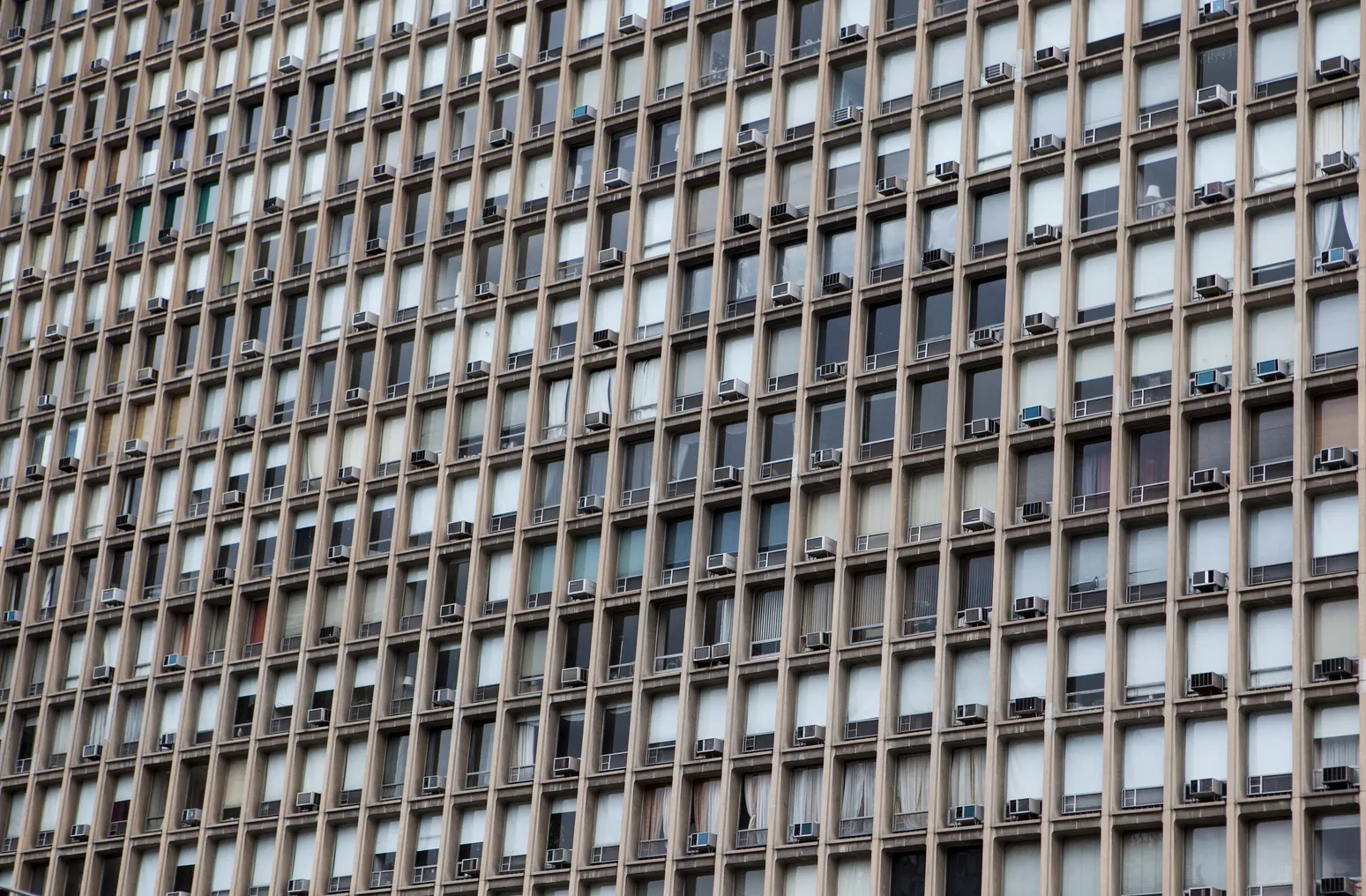 Window AC units in a large building from the outside.