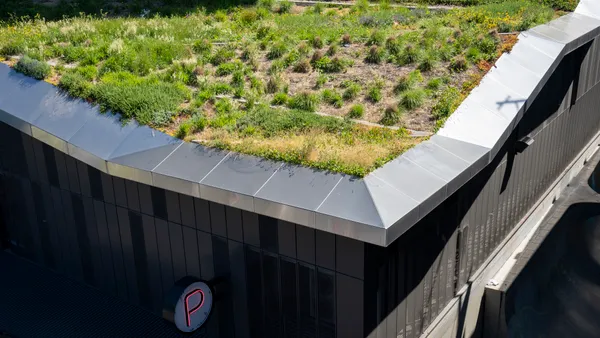 Aerial view of vegetation on the roof of a large building.