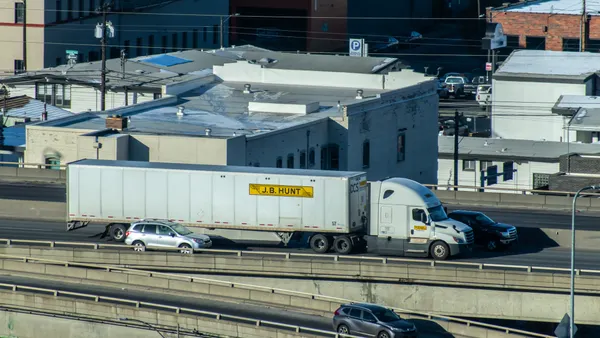 A J.B. Hunt Transport Services tractor-trailer on Interstate 90 in downtown Spokane, Washington, with passenger traffic.