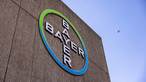 The Bayer logo hangs on the side of a building.