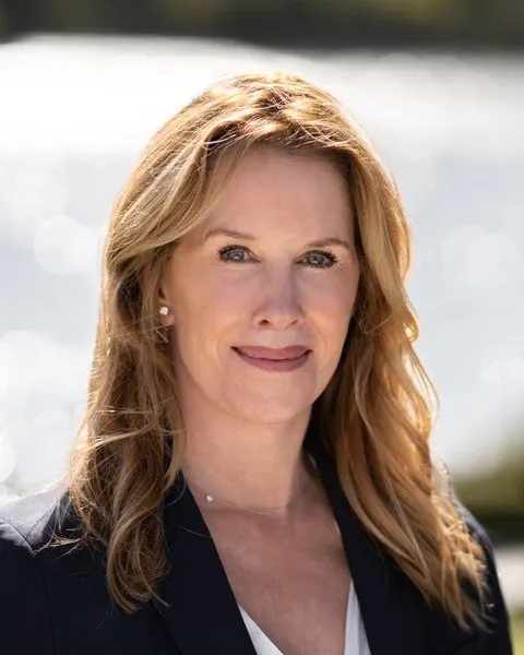 A woman smiles at the camera.