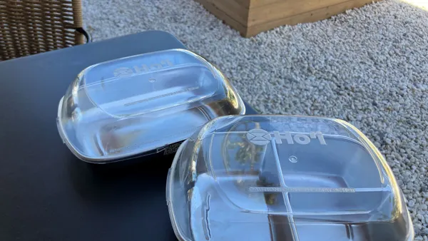 Two food service containers with Ho'i name on them