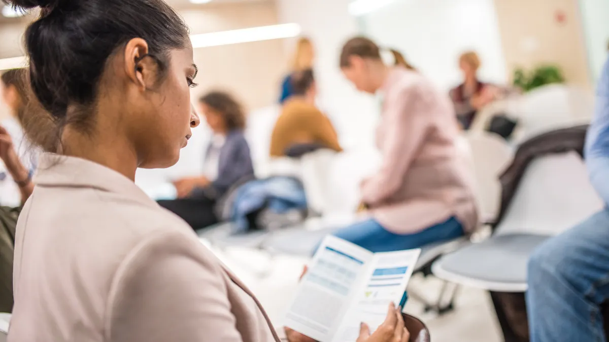 Woman reading brochure in a clinic