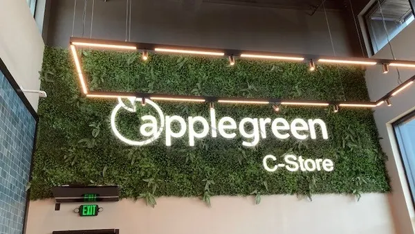 A photo of the inside of a convenience store. A sign on the wall says Applegreen c-store.