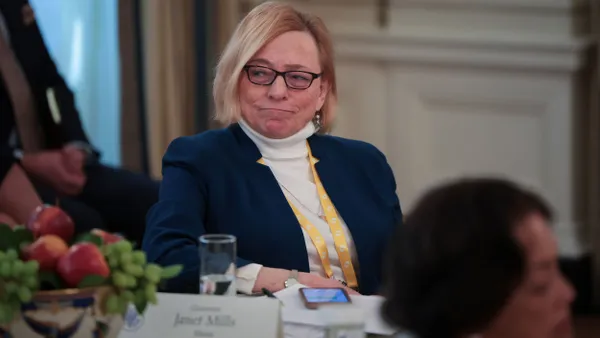 Janet Mills sits at a table at the White House during a governors meeting with President Donald Trump.