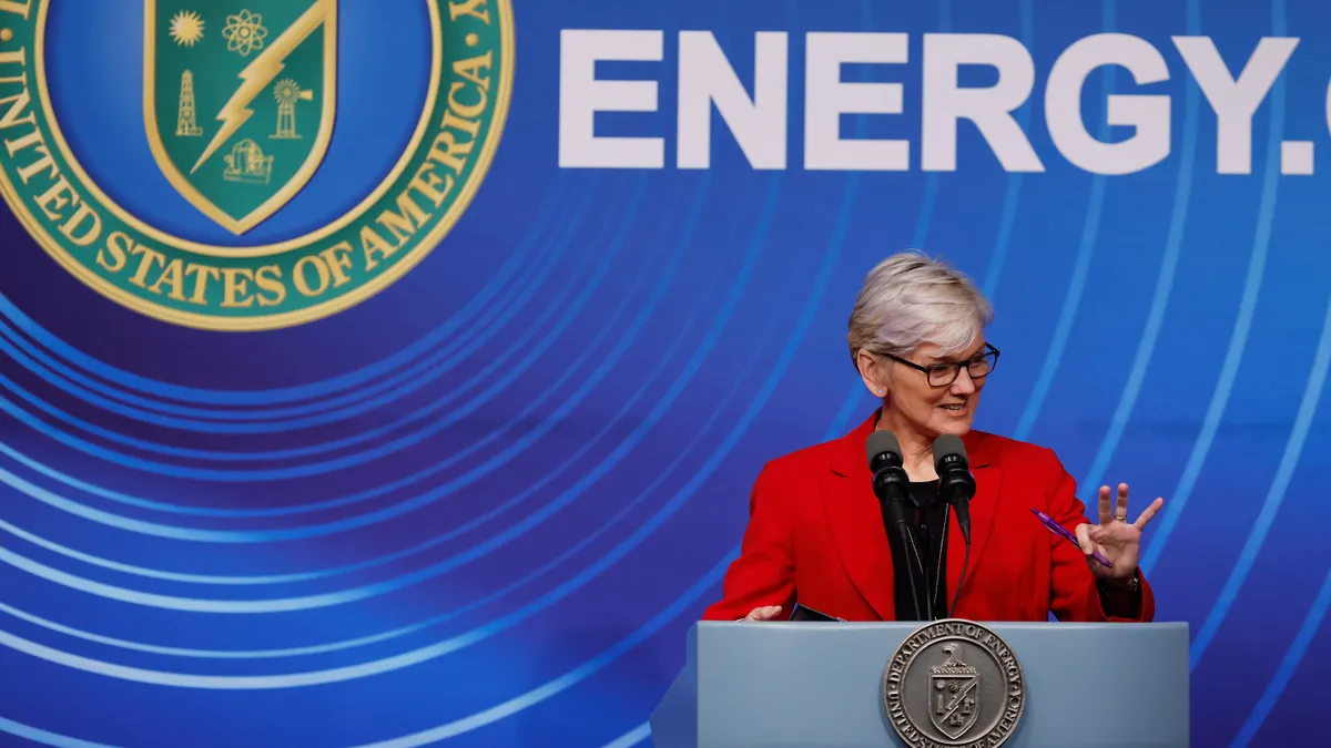 Energy Department Secretary Jennifer Granholm behind a podium speaking.