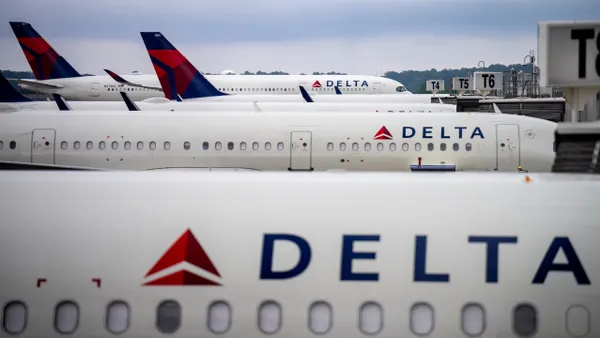 a row of Delta planes on an airport tarmac