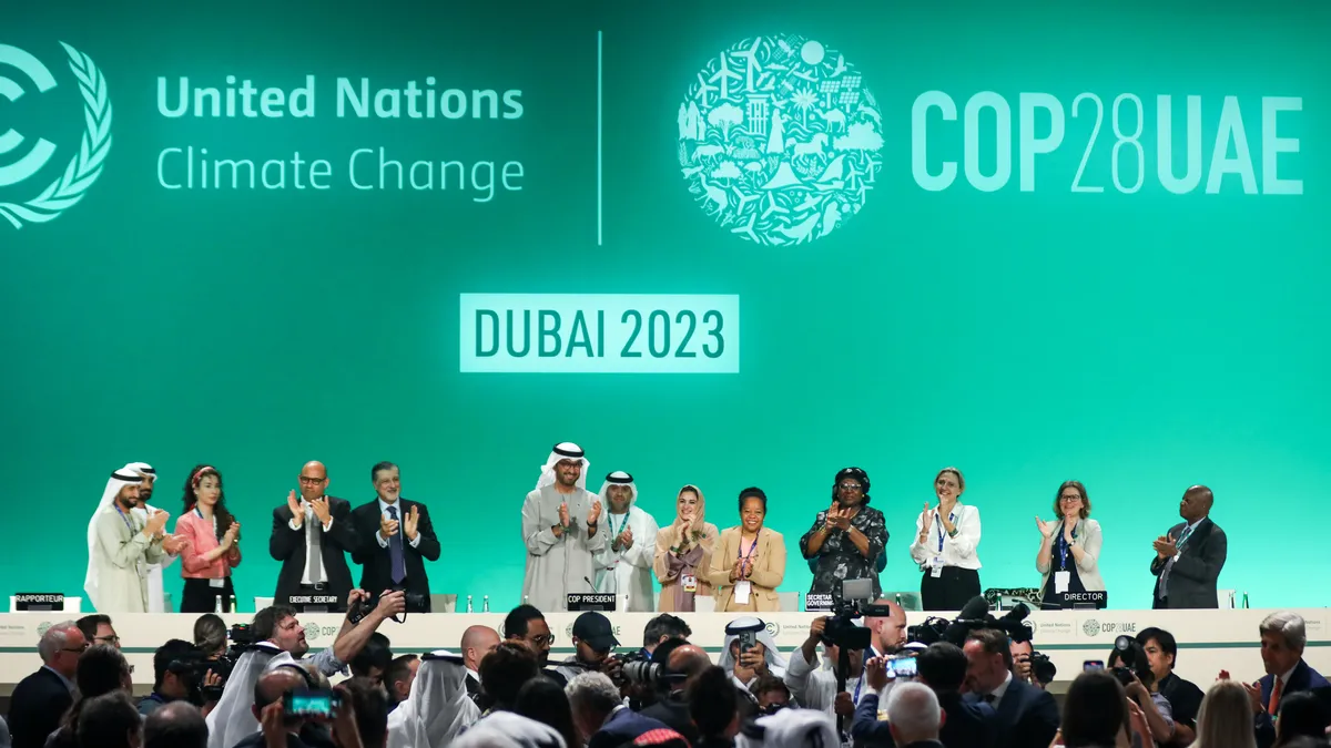 Delegates applaud after a speech by Sultan Ahmed Al Jaber, president of the UNFCCC COP28 Climate Conference.