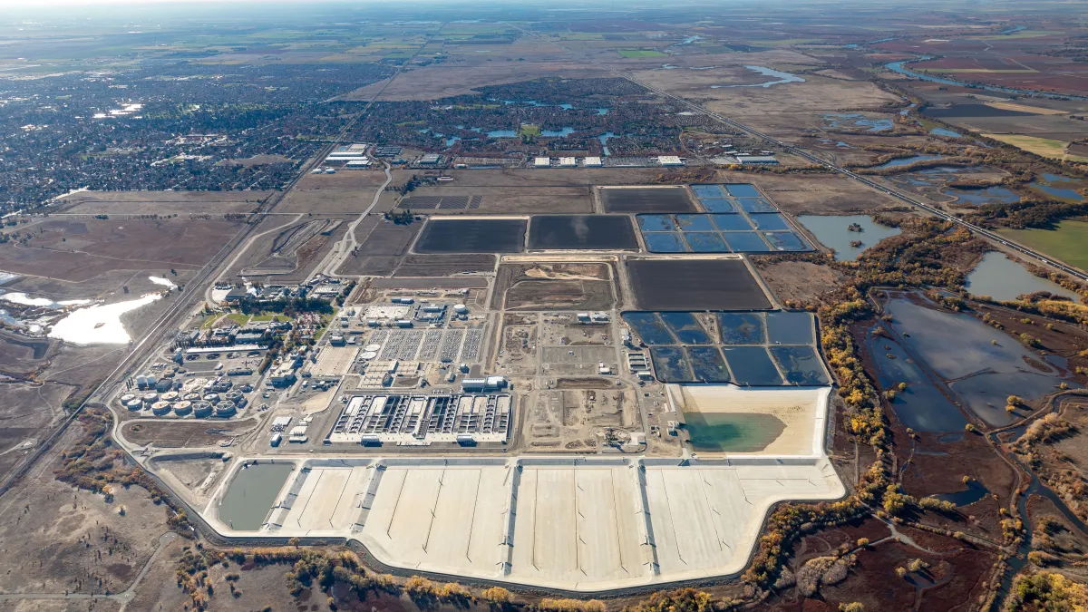 An overhead shot of a massive water treatment plant. It is an industrial complex that features little vegetation surrounding the area.