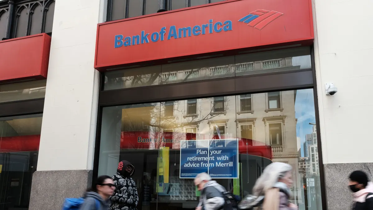 Pedestrians pass by a Bank of America branch.
