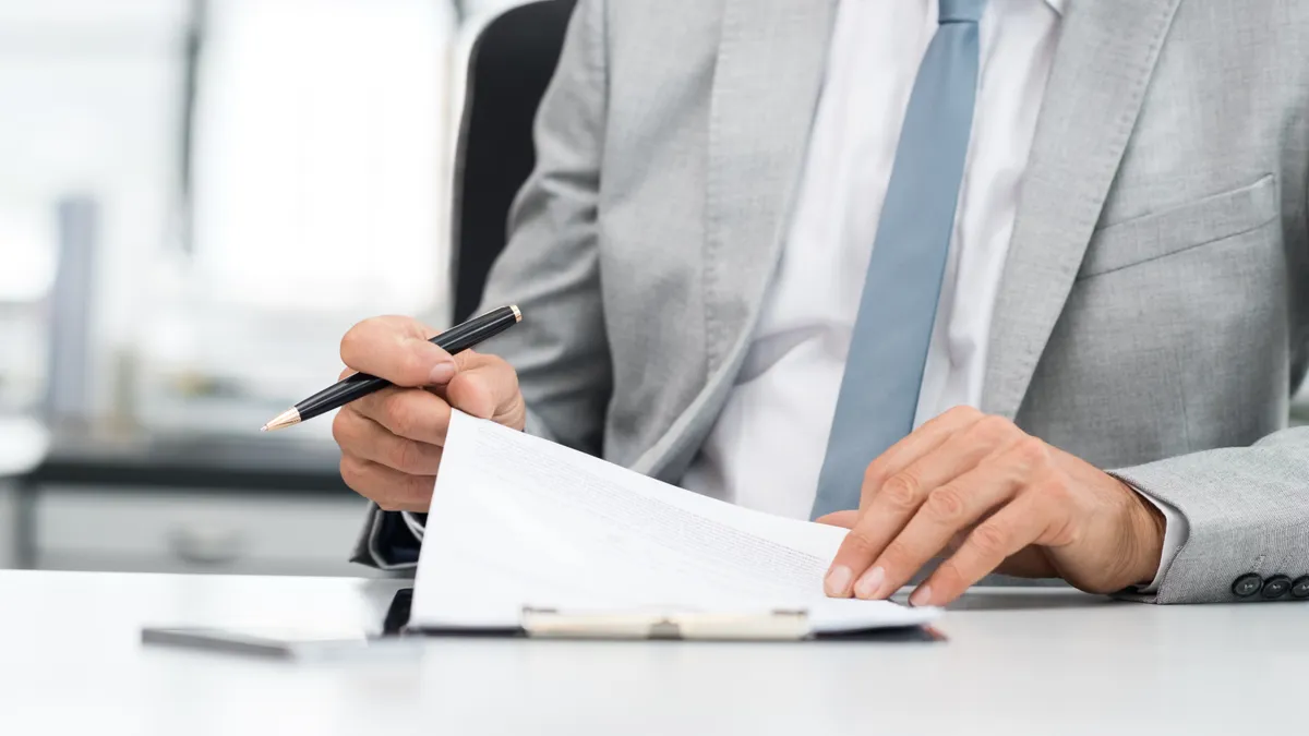 Businessman signing document