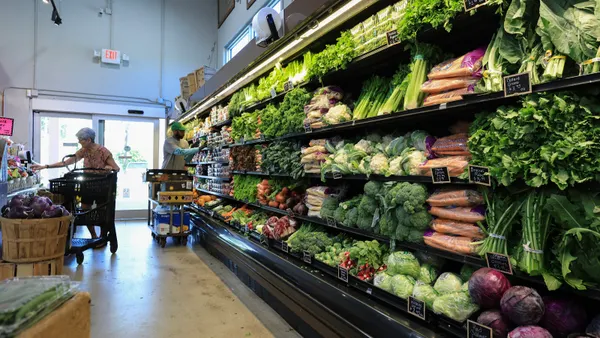 Vegetables sit on grocery store shelves