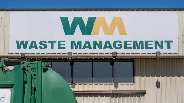 A close up of the WM - Waste Management logo