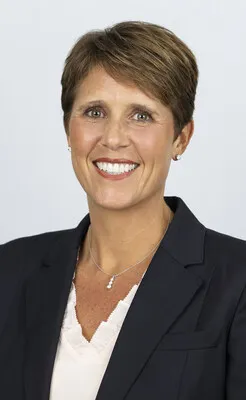 Susan Smith wearing a black blazer in front of a white background.