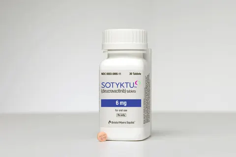 An image of a pill bottle next to a tablet of Sotyktu, a psoriasis medicine from Bristol Myers Squibb.