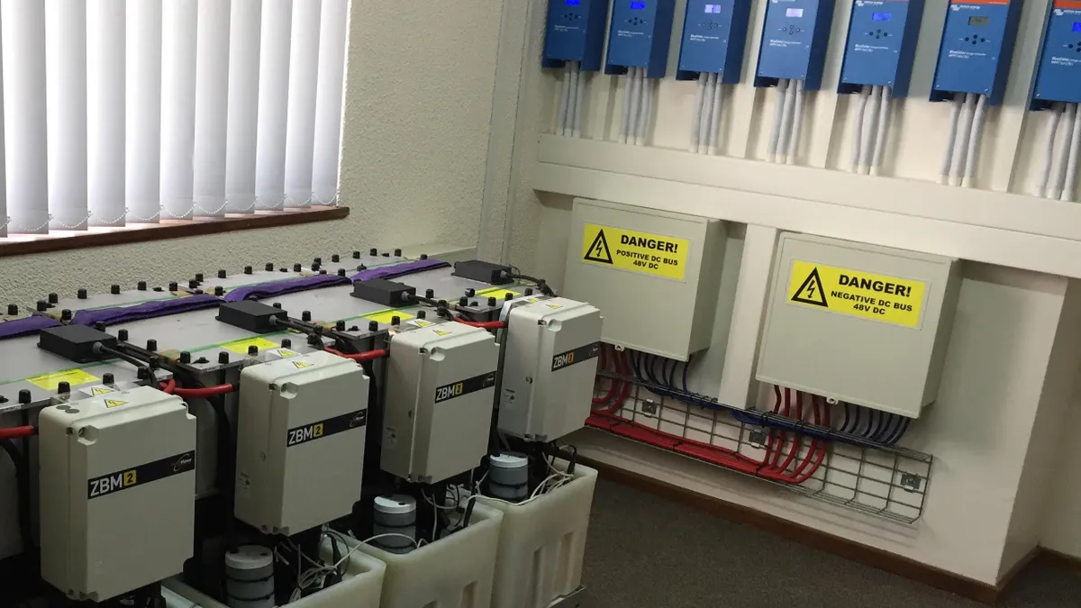 Equipment in a room with cables running into blue boxes.