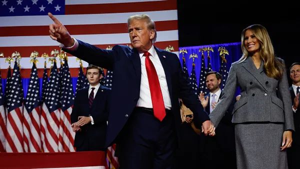 Republican presidential nominee, former U.S. President Donald Trump points to supporters with former first lady Melania Trump during an election night event at the Palm Beach Convention Center on November 06, 2024 in West Palm Beach, Florida.