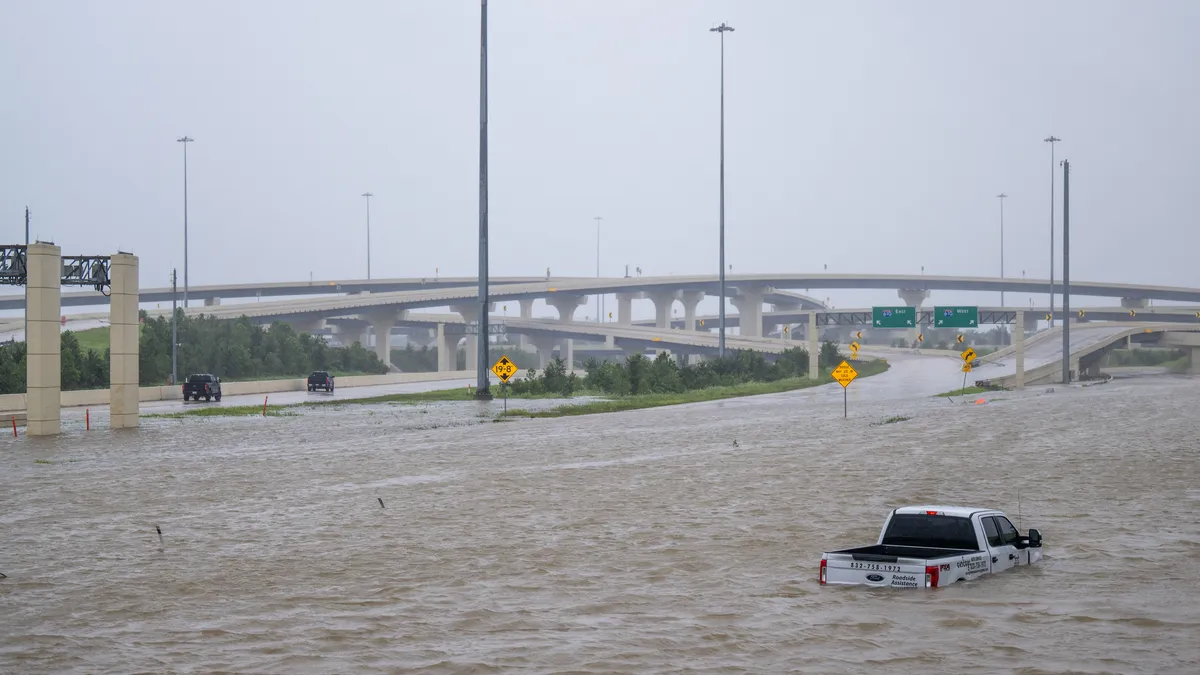 A truck is stranded on a flooded highway.