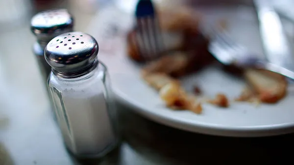 Salt and pepper shakers are seen in a diner