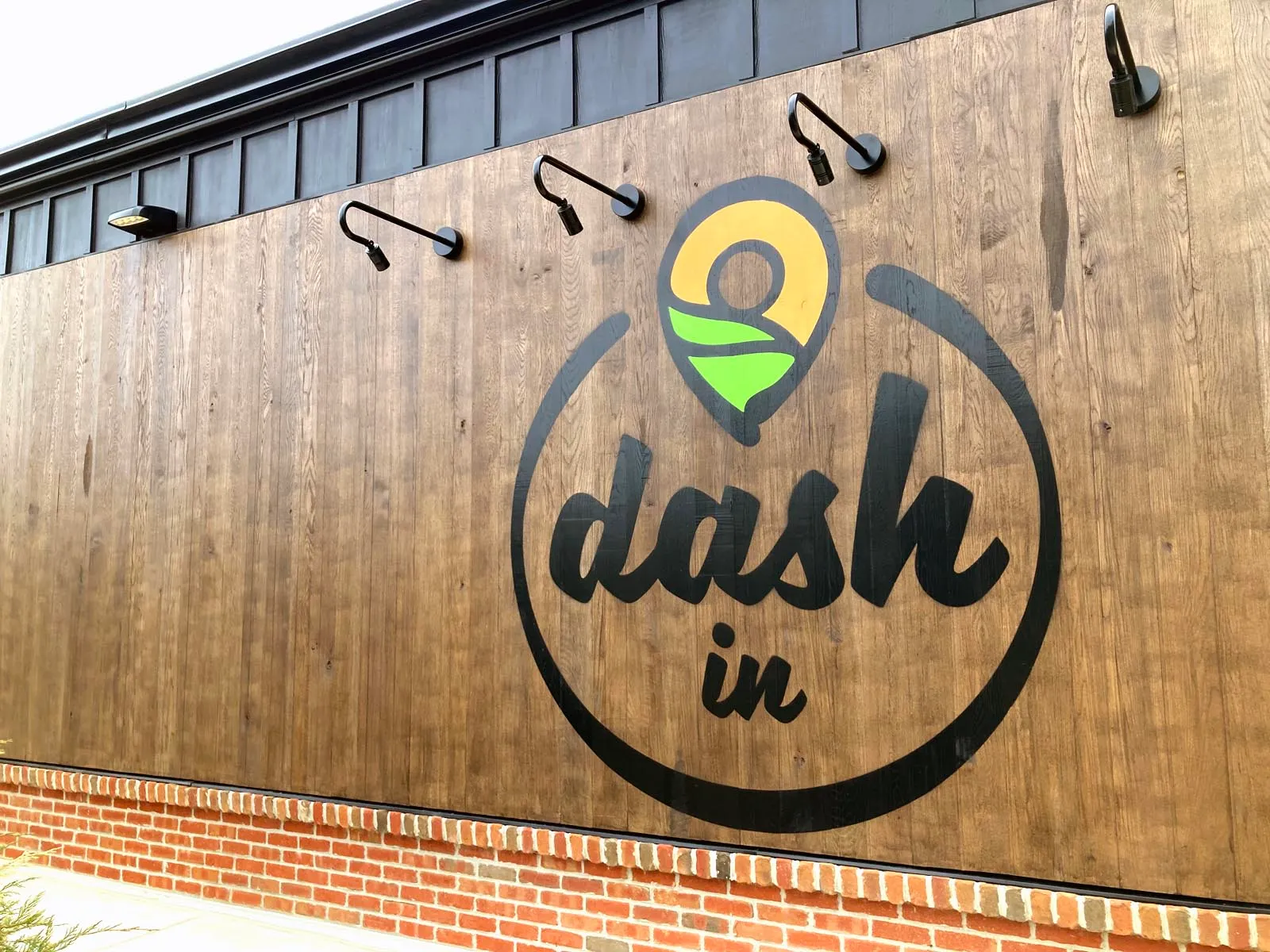 A photo of Dash In's new logo on the side of its new concept store.